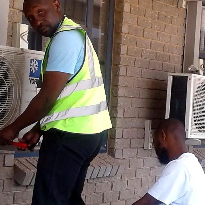 Mobile Fridge Repairs technician installing an aircon unit on site