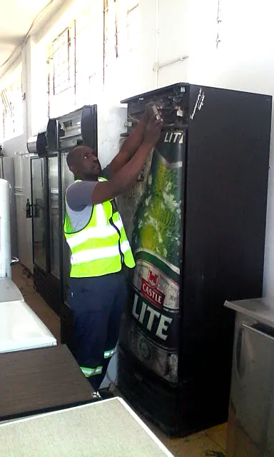 Commercial display fridge being repaired by Mobile Fridge Repairs
